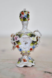 Floral Encrusted Porcelain Small Urn with Putti